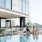 Apartments For Rent In The Gulch, Nashville, TN - 1200 Broadway - 70-Foot Lap Pool Next To Lounge Area With City Skyline Views.