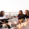 Large rooftop patio with seating at a fire pit 
