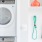 Studio Apartments In The Gulch, Nashville, TN - 1200 Broadway - Stackable Washer And Dryer Next To A Nest Thermostat And Storage Hanging Rack.