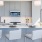 Spacious and well lit kitchen with wood floors and stainless steel appliances. 