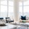 Spacious and well lit living room with wood floors and an open floor plan with access to the kitchen.